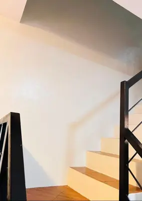 a set of stairs in a room with white walls at Transient Room in Dasmariñas