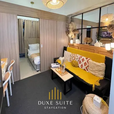 a living room with a yellow couch and a bedroom at Aesthetic walking distance to MOA,near NAIA AIRPORT with NETFLIX,MINIVIDEOKE,BOARDGAMES-DUXE5 in Manila