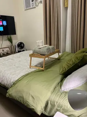 a bed with a table on top of it at Aesthetic Studio Unit at Deca Cubao QC in Manila