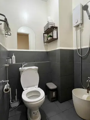 a bathroom with a toilet and a sink at Aesthetic Studio Unit at Deca Cubao QC in Manila