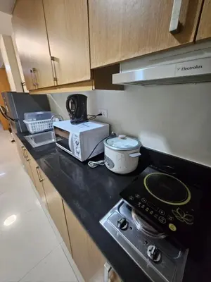 a kitchen with a stove and a toaster on a counter at Staycation with Netflix in Shell Residences in Manila