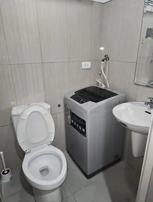 a small bathroom with a toilet and a sink at Staycation with Netflix in Shell Residences in Manila