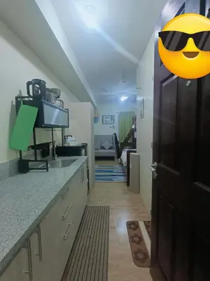 a kitchen with a smiley face on the door at DongStay in Bayabasan