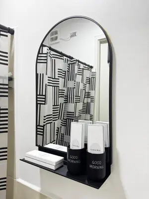 a mirror on a shelf with a black and white pattern at Casa Dreamer in Taytay