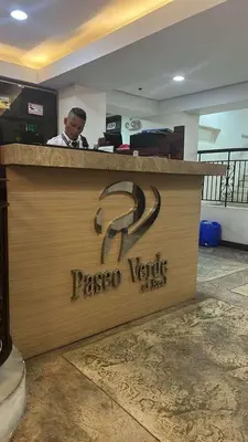a man sitting at araxoco verific sign on a counter at Nature Green Room Paseo Verde at Calle Real in Manila