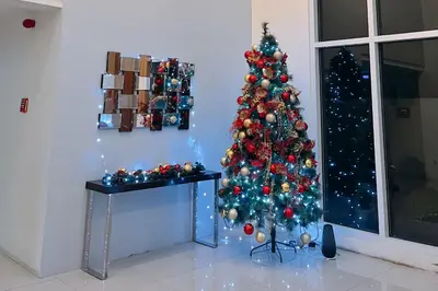a christmas tree in the corner of a room at Cozy Elegance Staycation in Silang