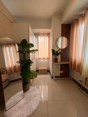 a hallway with a mirror and a potted plant at Sea Residences Spacious Unit by Ellenn in Manila