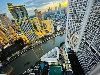 a view of a city with a river and buildings at Aveline Suites Sunrise 2bedroom in Manila