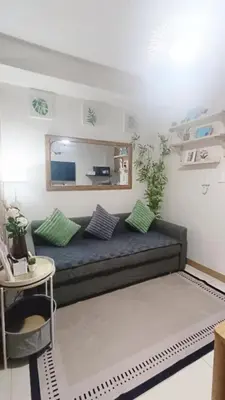 a living room with a couch and a table at Cozy Space at Red Makati City in Manila