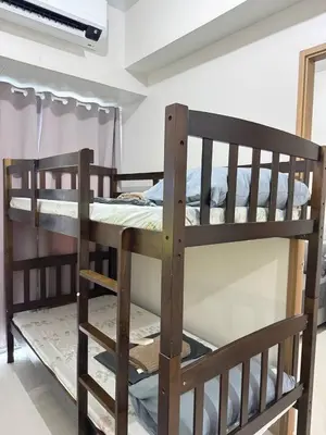 two wooden bunk beds in a room with a window at Unistay Shore 3 Tower 2 10th floor near MOA and AIRPORT in Manila