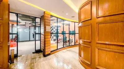 a large wooden door in a room with windows at Poblacion Stay with Pool Gym Jacuzzi and Pool Table in Manila