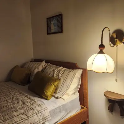 a bedroom with a bed with a light and a lamp at MOA Staycation The Baycourt at Shore Residences Near Mall of Asia IKEA NAIA SMX Convention Center MOA Concert Grounds in Manila