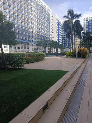a park in front of a large building at Sea residence in Manila