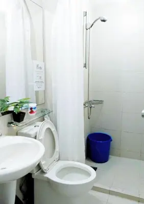 a bathroom with a toilet and a sink and a shower at Azure Staycationcation by Nairah in Manila