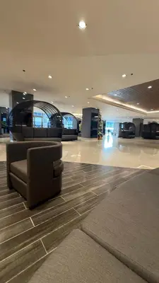 a lobby with a couch in the middle of a building at Shore Residecnes Infront of MoA, Netflix, Wifi in Manila