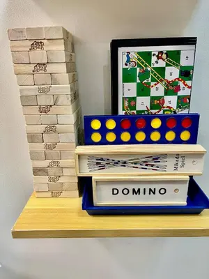 a stack of dominoes on a shelf with books at Jessa Rios Coast Staycation 2 in Manila