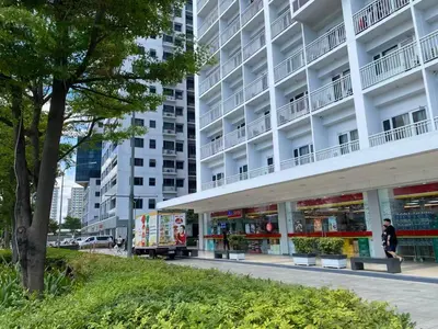 a person walking in front of a building at 1BR 2 Beds Family Friendly near MOA - 9119C in Manila