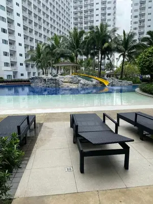 a pool with benches and a fountain in a building at 1BR 2 Beds Family Friendly near MOA - 9119C in Manila