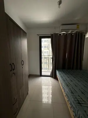 a bedroom with a bed and a large window at 1 Bedroom Shore Residences 2 For Rent in Manila