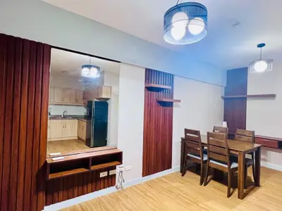 a kitchen and dining room with a table and chairs at Resort inspired Alea residences in Manila