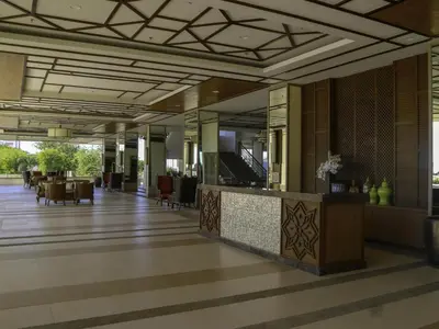 a lobby of a hotel with a reception desk and chairs at Resort inspired Alea residences in Manila