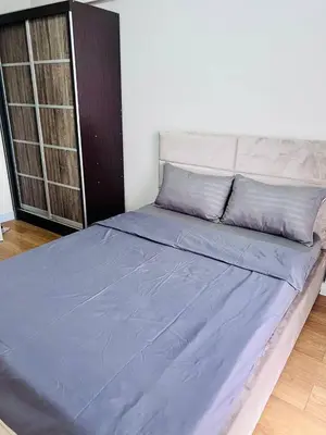 a large bed with blue sheets in a room at Resort inspired Alea residences in Manila