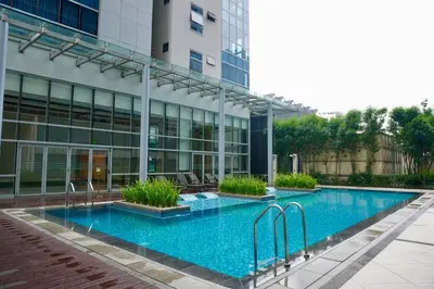 a swimming pool in front of a building at Bright Corner 2BR Suite with Bathtub Uptown BGC in Manila