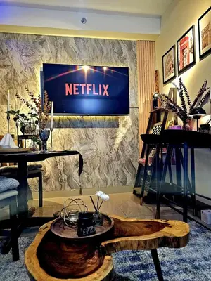 a living room with a netflix sign on a wall at Irene's luscious place in Manila