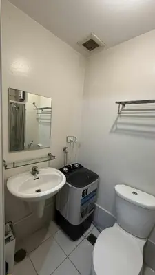 a white bathroom with a toilet and a sink at Princeton condo near gilmore STA Wifi Netflex in Manila