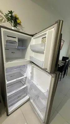 an empty refrigerator with its door open in a kitchen at Princeton condo near gilmore STA Wifi Netflex in Manila