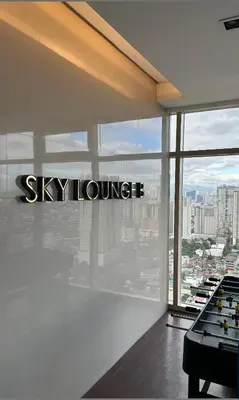 a room with the sky lounge sign on the window at Near SM MOA in Manila