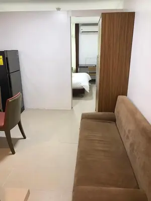 a living room with a couch and a bed at Antel Spa Residences 10B in Manila