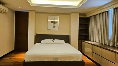 a bedroom with a large bed in a room at 2 Bedroom Urban Oasis Poblacion in Manila