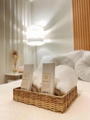 a basket of towels and towels on a bed at La Luana Mnl in Manila