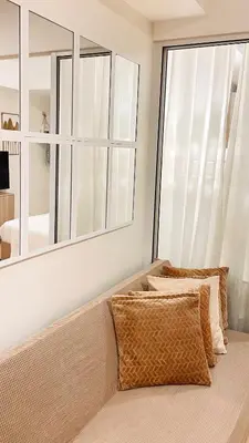 a living room with a couch and a large window at La Luana Mnl in Manila