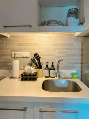 a kitchen with a sink and a counter top at La Luana Mnl in Manila