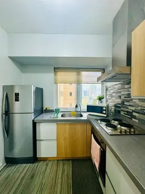 a kitchen with a stainless steel refrigerator and a sink at Cozy Haven in Manila