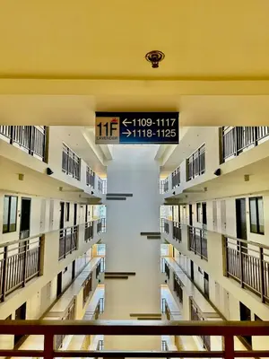 an empty hallway of a hospital with a sign at YourSafeHaven Calathea Place Lavender Bldg in Manila