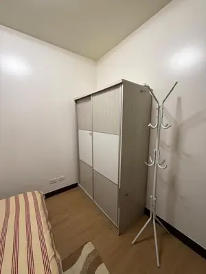 a room with a bed and a cabinet in it at YourSafeHaven Calathea Place Lavender Bldg in Manila