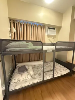 a couple of bunk beds in a room at Aesthetic Cozy Modern Condo Apartment in Manila