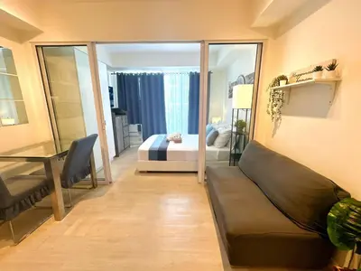 a living room with a couch and a bedroom at 1BR Condotel in Azure Urban Resort Near NAIA #BH1 in Manila