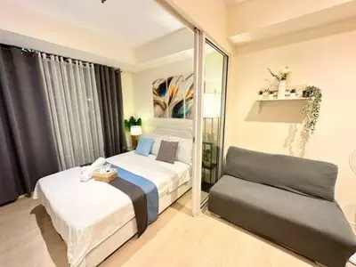 a hotel room with two beds and a mirror at 1BR Condotel in Azure Urban Resort Near NAIA #BH1 in Manila