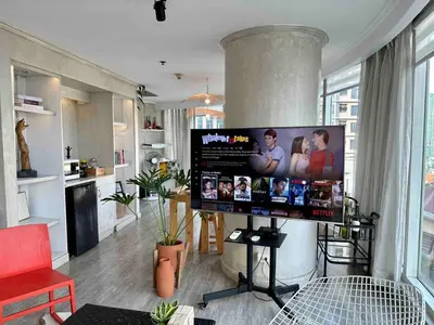 a living room with a large flat screen tv at 55-SQM The Urban Cabin in Poblacion Makati in Manila