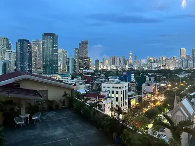 a view of a city skyline at night at 55-SQM Urban Cabin in Poblacion Makati in Manila