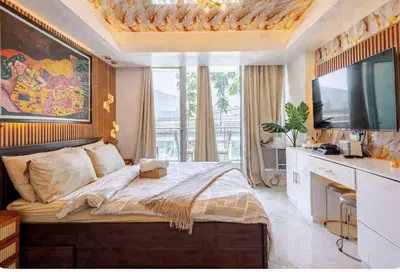 a bedroom with a large bed and a flat screen tv at Homesweethome Beach Resort in Manila