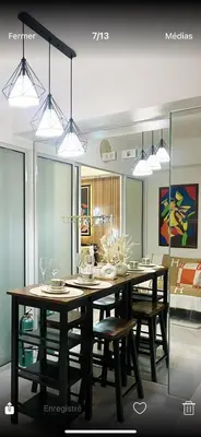 a dining room with a table with chairs and lights at Homesweethome Beach Resort in Manila