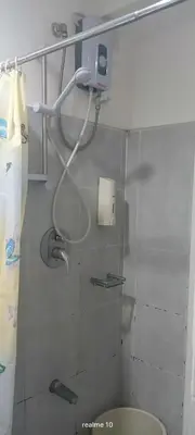 a bathroom with a toilet and a phone on the wall at Sea Residences Jhayrose Staycation in Manila