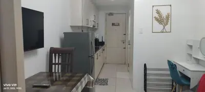 a kitchen with a refrigerator and a table and a chair at Sea Residences, Pkwy, Pasay City 1300, Philippines in Manila