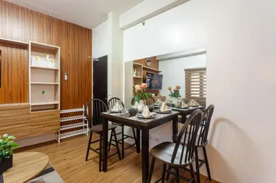 a dining room with a table and chairs at Luxurious & Elegant Vibe in Newport City Pasay in Manila