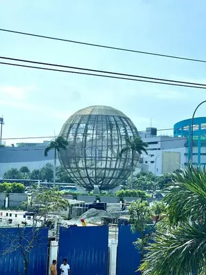 a large globe in the middle of a city at V&G Era Staycation in Manila